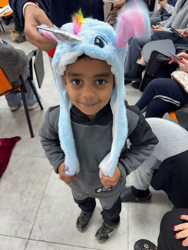 Young child smiling with a toy received as a gift