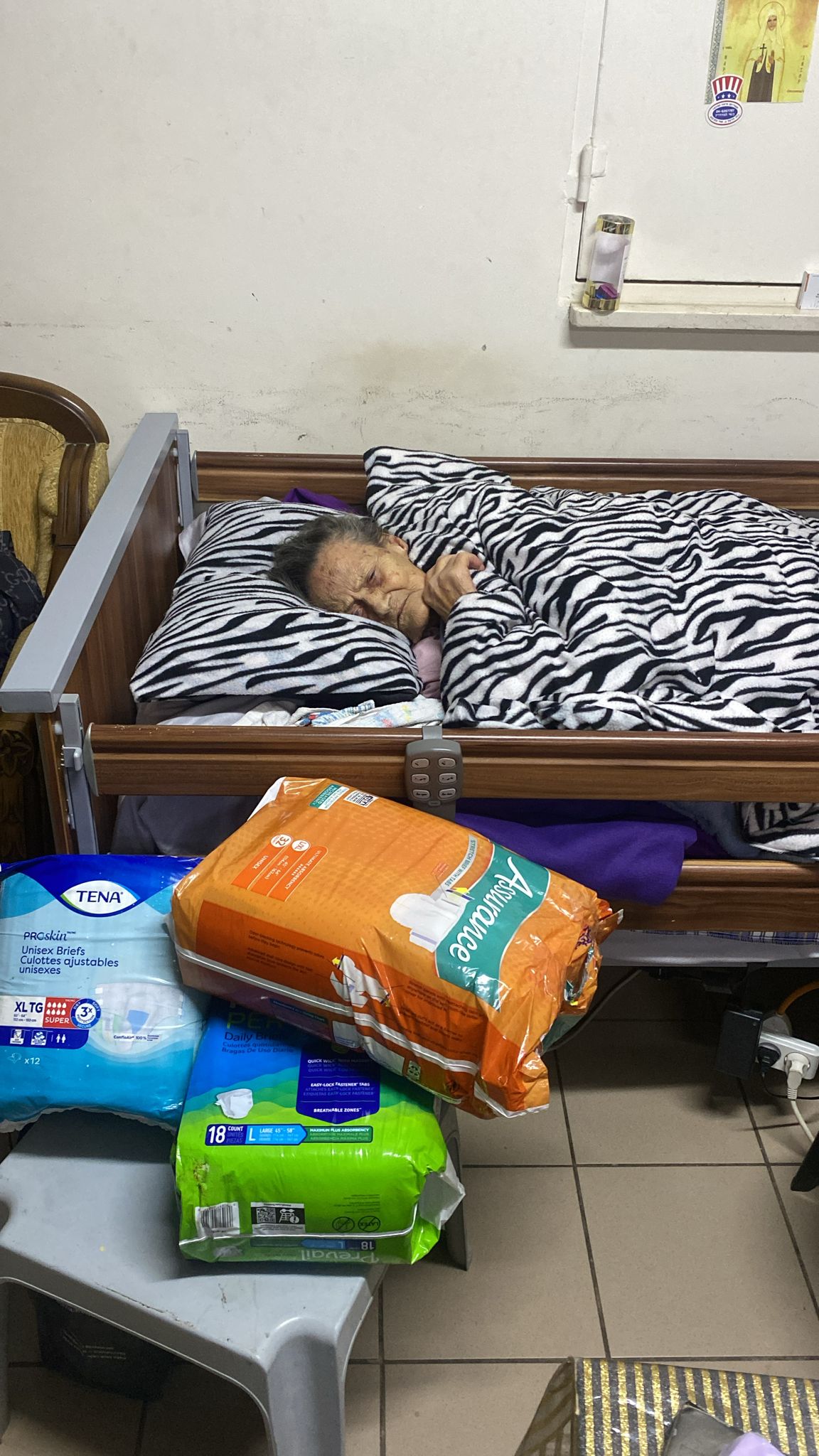 Elderly woman receiving humanitarian aid during the war